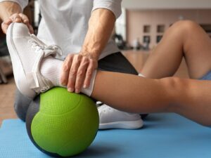 fisioterapeuta con paciente haciendo fisioterapia deportiva